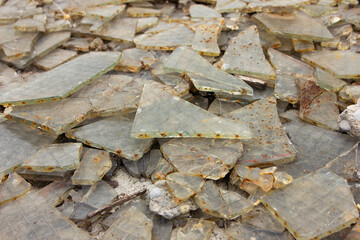 Broken glass. Construction waste. Construction site consequences. Glass chips
