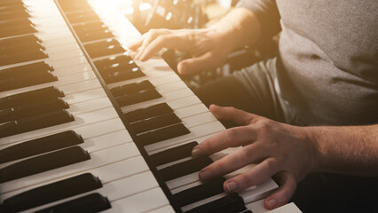 Man hands playing on a double keyboards closeup