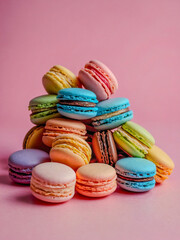 Colorful macaroons against a pink background.