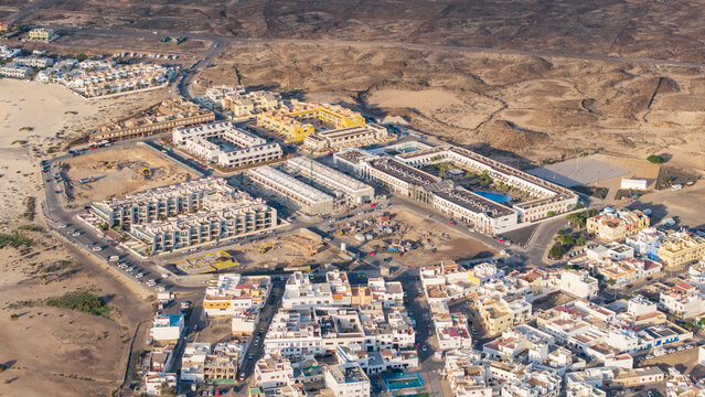 Aerial view of el cotillo town with modern buildings and sandy coastline, fuerteventura island, canary islands, spain.