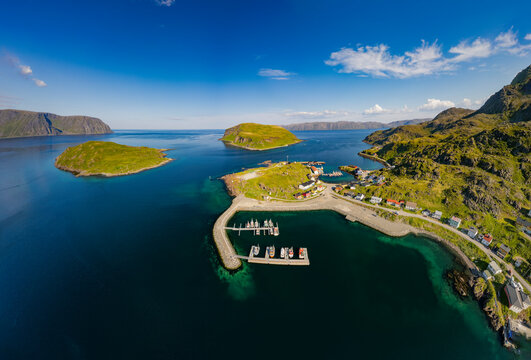 Aerial view of a traditional fishing village with houses and a harbor, Kamoyvaer, Mageroy island, Finnmark, Norway.