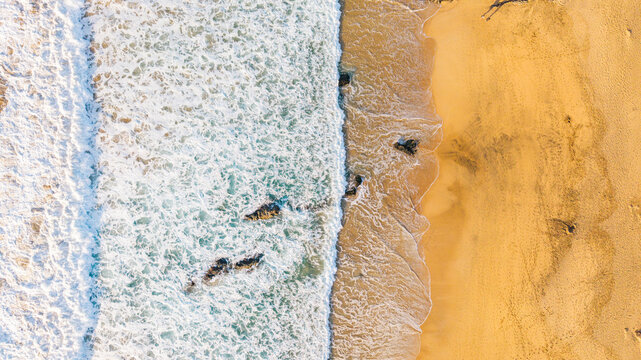 Aerial view of cotillo beach with beautiful waves and sandy shoreline, Fuerteventura Island, Canary Islands, Spain.