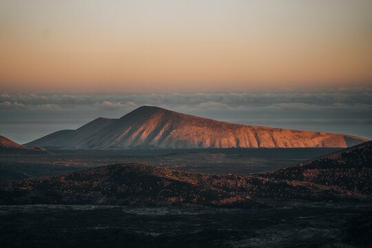 Aerial view of a majestic volcanic landscape at sunset with serene mountains, Fuente de Montana Negra, Lanzarote, Canary Islands, Spain.