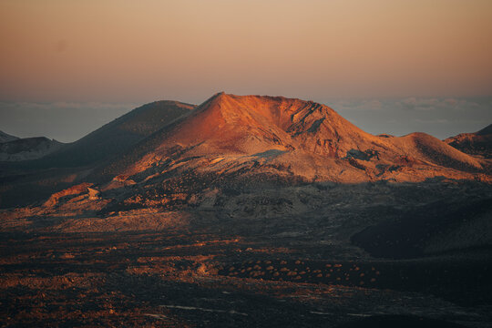 Aerial view of a breathtaking sunset over the rugged volcanic landscape of Fuente de Montana Negra, Lanzarote, Canary Islands, Spain.