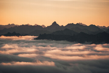 Aerial view of majestic Alps at sunrise with clouds and serene landscape, Brulisau, Appenzell, Switzerland.