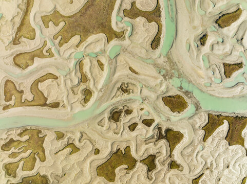 Aerial view of beautiful marshland and wetland patterns in low tide, Bahia de Cadiz, Cadiz, Spain.