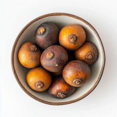 Fototapeta premium Rustic Bowl of Dried Fruit: A Collection of Brown and Yellow Nuts and Berries with a Textured Ceramic Background