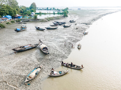 Feni, Bangladesh - 18 September 2024: Aerial view of fishing boats on flood water with a rural landscape and community resilience, Feni, Chittagong, Bangladesh.