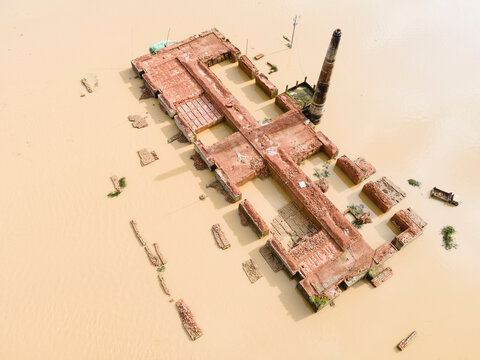 Aerial view of a flooded village with submerged buildings and vehicles, Chhagalnaiya, Feni, Chittagong, Bangladesh.