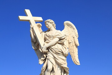 Angel with the Cross Statue Detail with Bright Blue Sky at Ponte Sant'Angelo Bridge in Rome, Italy, March 2025