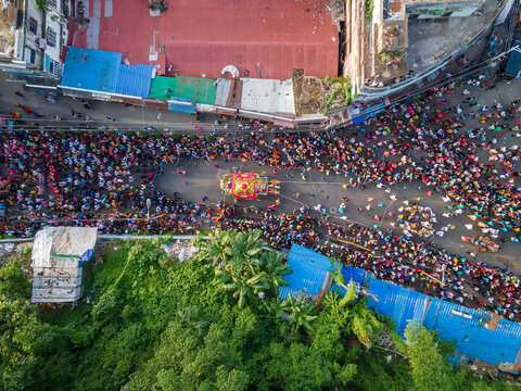 Chittagong, Bangladesh - 20 June 2023: Aerial view of colorful Rath Yatra festival procession with a vibrant crowd in urban setting, Chittagong, Bangladesh.
