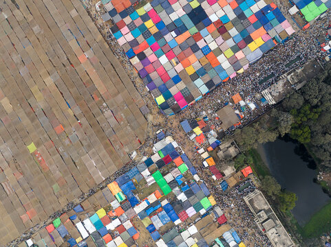 Aerial view of a vibrant and bustling street market with colorful stalls and people engaging in trade, Tongi, Gazipur, Bangladesh.