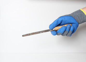 file in the hand in a blue glove