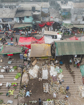 Dhaka, Bangladesh - 02 February 2025: Aerial view of bustling vegetable market with colorful stalls and vendors, Sutrapur Thana, Dhaka, Bangladesh.