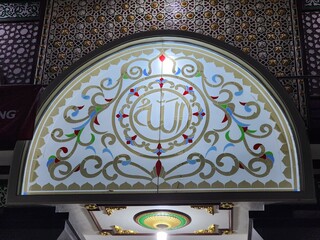 Details of the mosque's mihrab with engraving of Allah's words