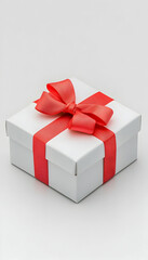 Obraz premium White gift box with red ribbon and bow