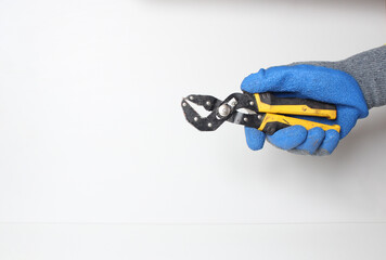 Universal wrench in the hand in a blue glove