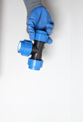 plumbing clutch in a blue glove