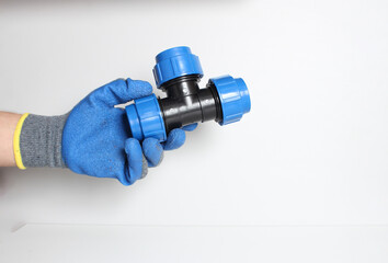 plumbing clutch in a blue glove