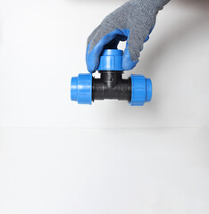 plumbing clutch in a blue glove