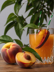 a glass of peach juice and one peach cut in half