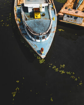 Aerial view of Dhaleshwari River with a traditional boat and brick factory, Baktaballi, Narayanganj, Dhaka, Bangladesh.