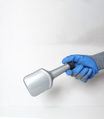 car bottle in the hand in a blue glove