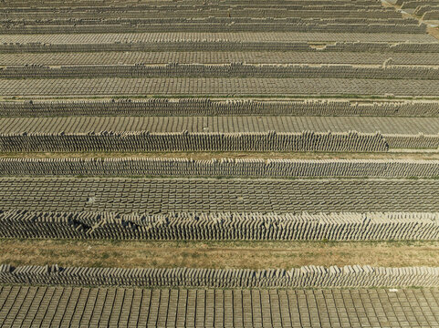 Aerial view of brick fields with organized rows and patterns, Suti Para Union, Dhamrai, Dhaka, Bangladesh.