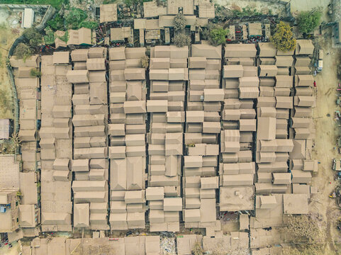 Aerial view of a bustling cattle market with organized rooftops and buildings, Darus Salam Thana, Dhaka, Bangladesh.
