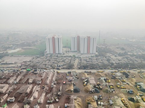 Aerial view of cement industries and high-rise buildings in an urban landscape, Darus Salam Thana, Dhaka, Bangladesh.