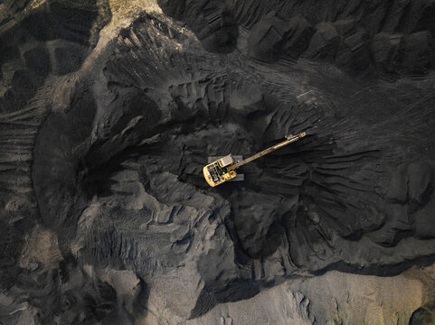 Aerial view of a coal factory with cranes and heavy machinery at an industrial site, Amin Bazar, Savar, Dhaka, Bangladesh.