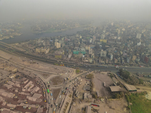 Aerial view of a densely populated urban landscape with high-rise buildings and a river, Darus Salam Thana, Dhaka, Bangladesh.