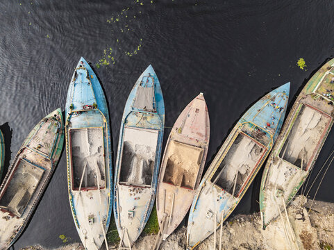 Aerial view of people working with traditional boats in Buriganga river near cement industries, Amin Bazar, Savar, Dhaka, Bangladesh.