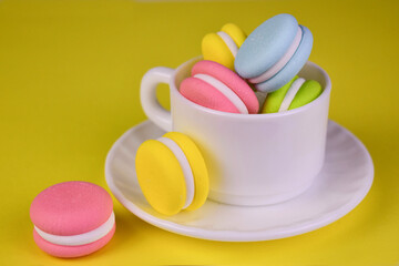 Macaron shaped candies in a cup. Close-up. Copy space.
