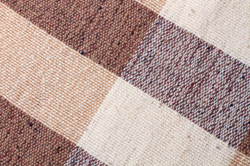 Brown and white checkered fabric texture in a close up view
