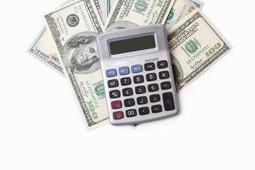One hundred dollar bills and a vintage calculator on a white background