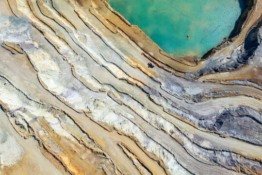 Aerial view of the industrial iron ore mine with exposed rock formations and scarred terrain, Erzberg, Styria, Austria.
