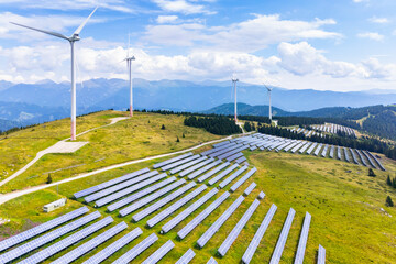 Aerial view of tauernwindpark with wind turbines and photovoltaic panels in a beautiful mountain range, Lachtal, Styria, Austria.