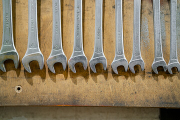 Industrial working wrench tool kit hanged on a wall in mechanic garage workshop, repairing tools ready for use and are used