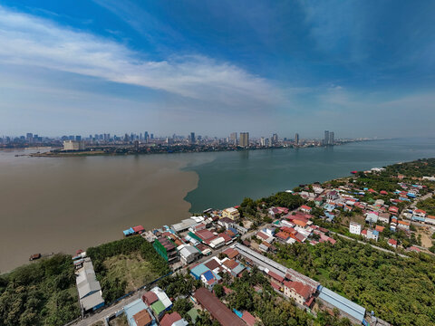 Aerial view of serene cityscape with residential buildings and rooftops along the Mekong and Tonle Sap rivers, Akreiy Ksatr, Lvea Aem District, Kandal, Cambodia.