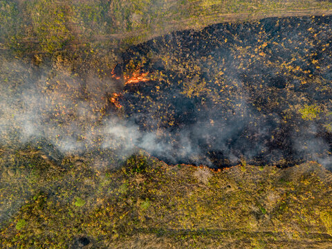 Aerial view of burning fields with smoke and charred earth from slash and burn agriculture, Sameakki, Stung Treng Municipality, Cambodia.