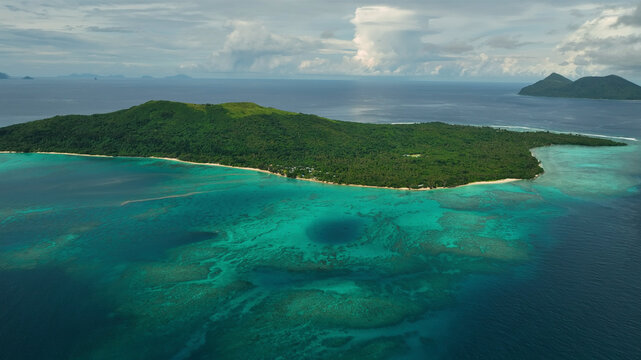 Aerial view of a tropical island with azure lagoon, coral reef, and lush greenery, Port Vila, Efate, Vanuatu.