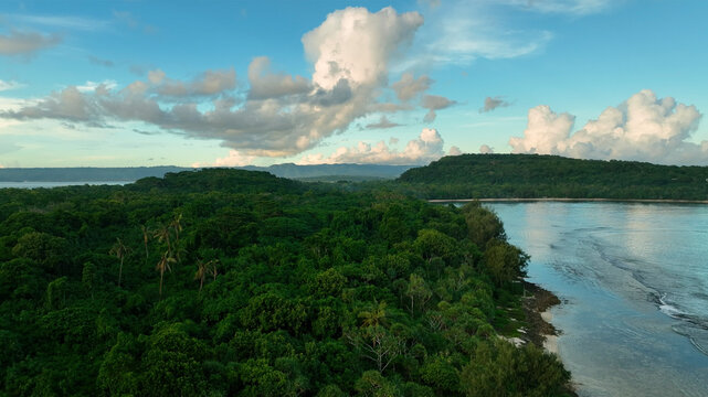 Aerial view of tropical sunset over the beautiful pacific ocean with lush forest and clouds, Port Vila, Efate, Vanuatu.