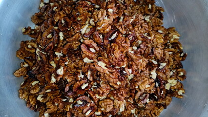 The photos show a lot of walnuts. A lot of walnuts piled up