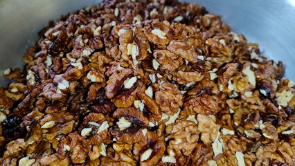 The photos show a lot of walnuts. A lot of walnuts piled up
