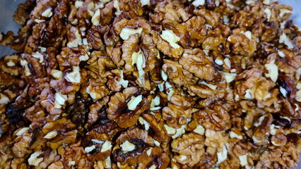 The photos show a lot of walnuts. A lot of walnuts piled up