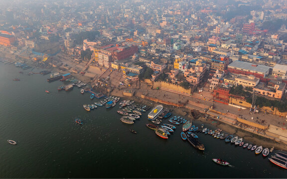 Aerial view of bustling Ganges river with colorful ghats and boats, Varanasi, Uttar Pradesh, India.