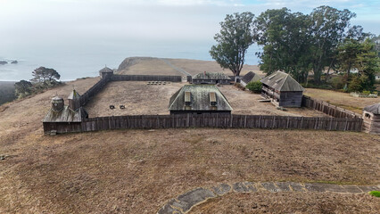 Aerial view of historic Fort Ross with wooden structures and scenic coastline, Fort Ross, California, United States.