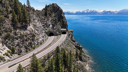 Aerial view of serene Cave Rock with a picturesque lake surrounded by majestic mountains and lush trees, Glenbrook, Nevada, United States.