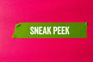 Sneak peek message written on ripped torn green paper tape on pink background. Conceptual sneak...
